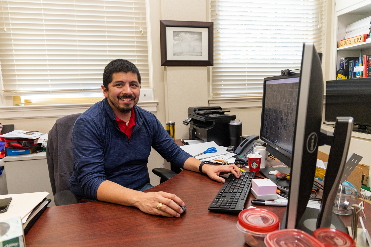 Matt Saldana, an instructor in the National Wind Institute, works at his desk. (Codi Clark/Texas Tech University)